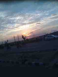 THE DUSKY SKY AND A WINDING ROAD CLICKED IN A MOVING BUS
